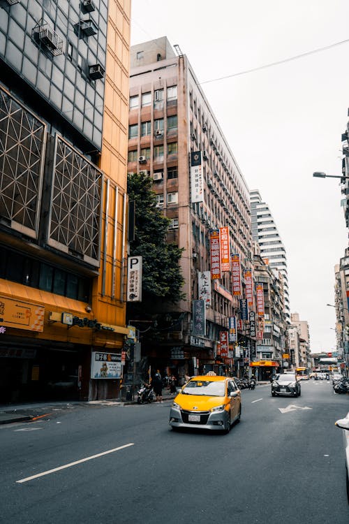 Yellow Taxi Car on Street