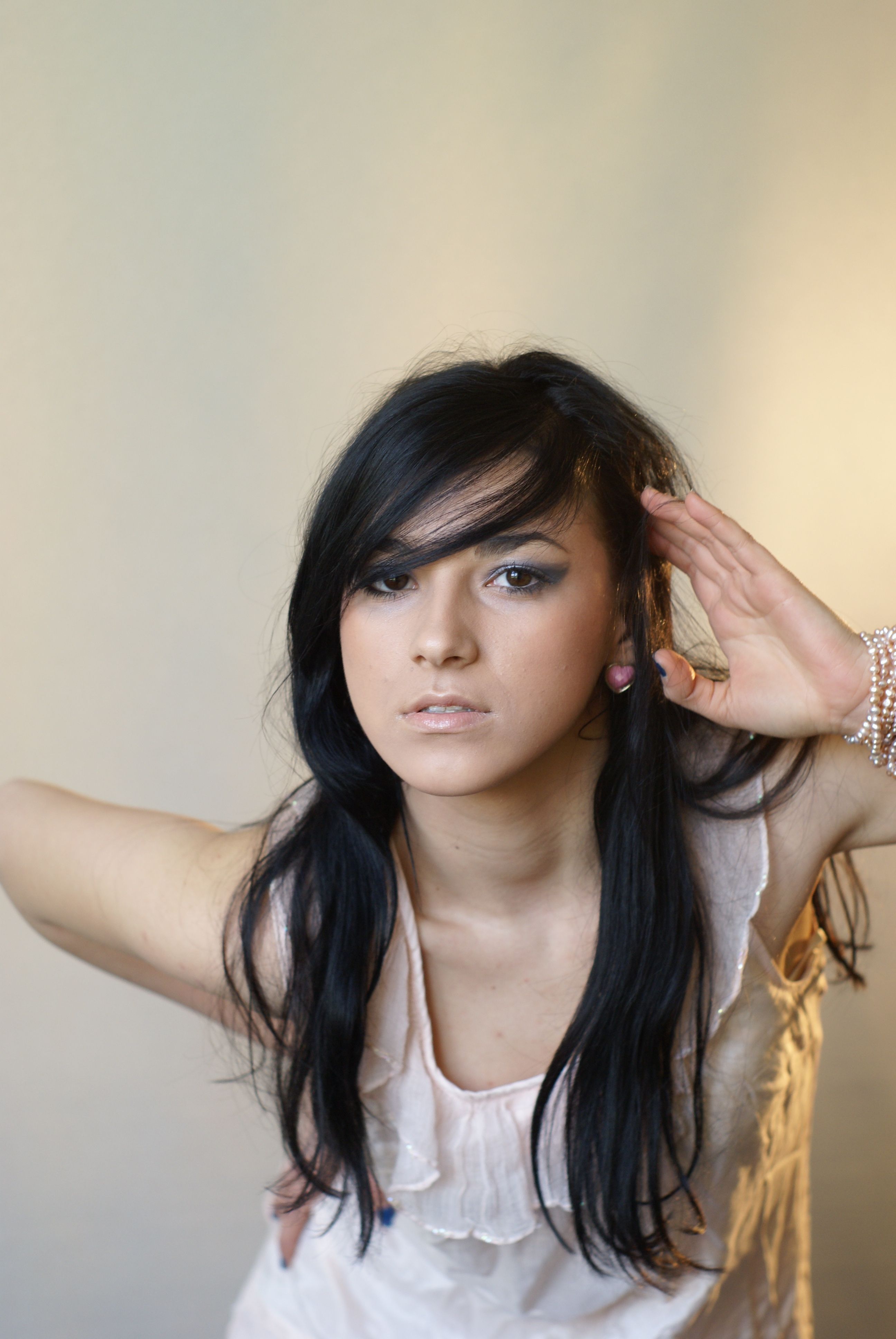 A woman with long black hair is posing for a photo · Free Stock Photo
