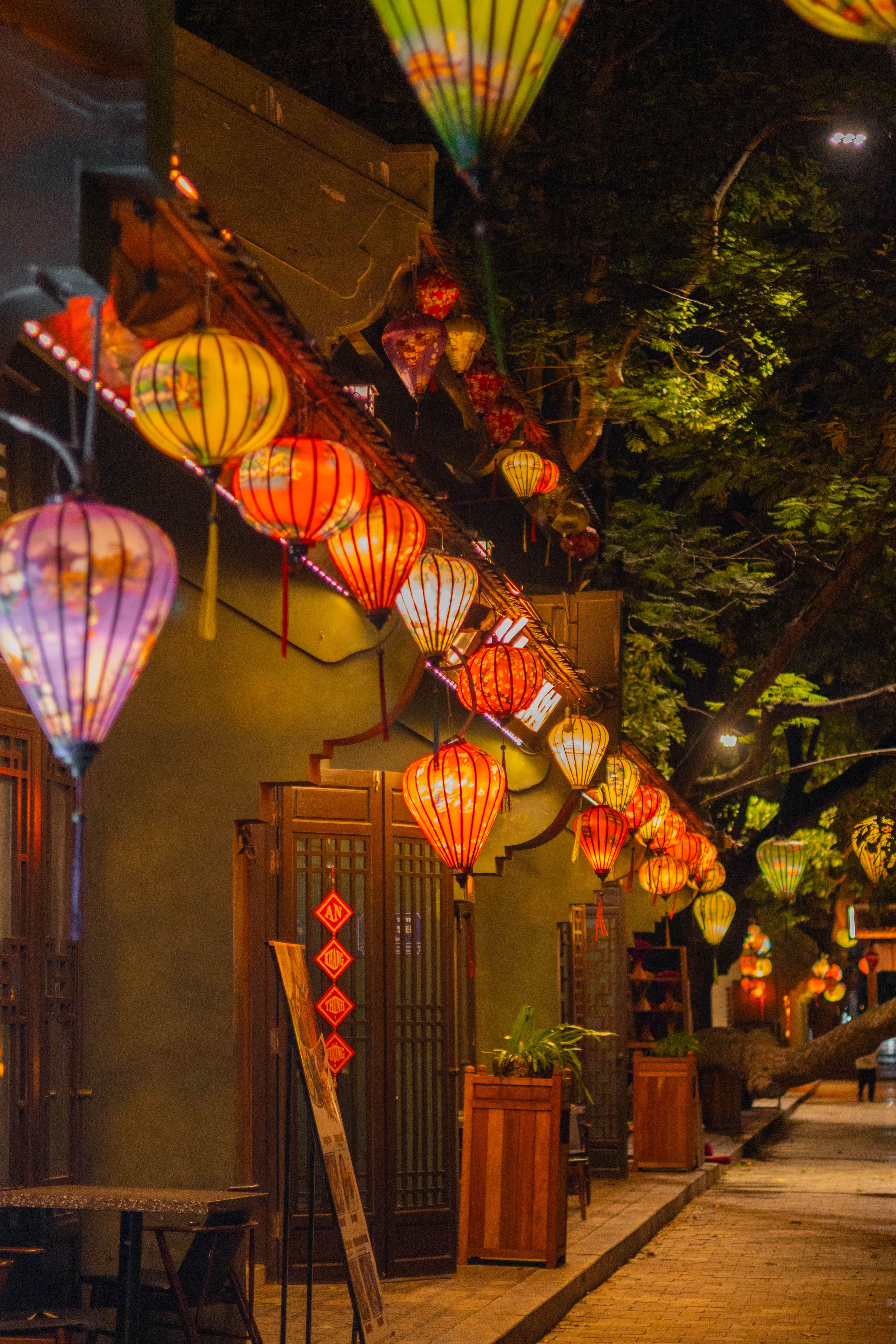 Vibrant lanterns illuminate city streets in Ninh Bình, Vietnam at night, capturing traditional urban charm.