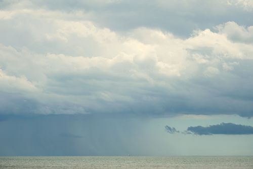 Free A stormy skyline with dark clouds over the sea near Chioggia, Italy, capturing a serene and moody atmosphere. Stock Photo