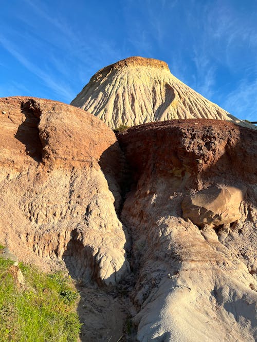 A large rock formation with a blue sky