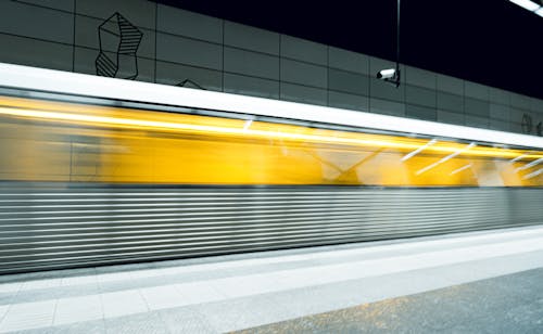 A train moving through a subway station at night