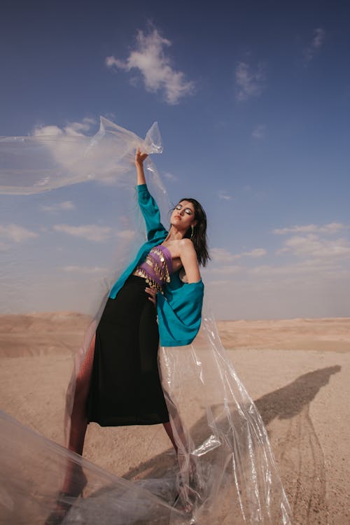 Woman Holding Foil on Desert