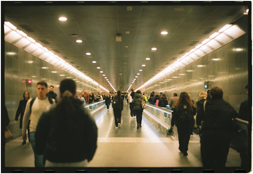 People Walking in Tunnel at Airport