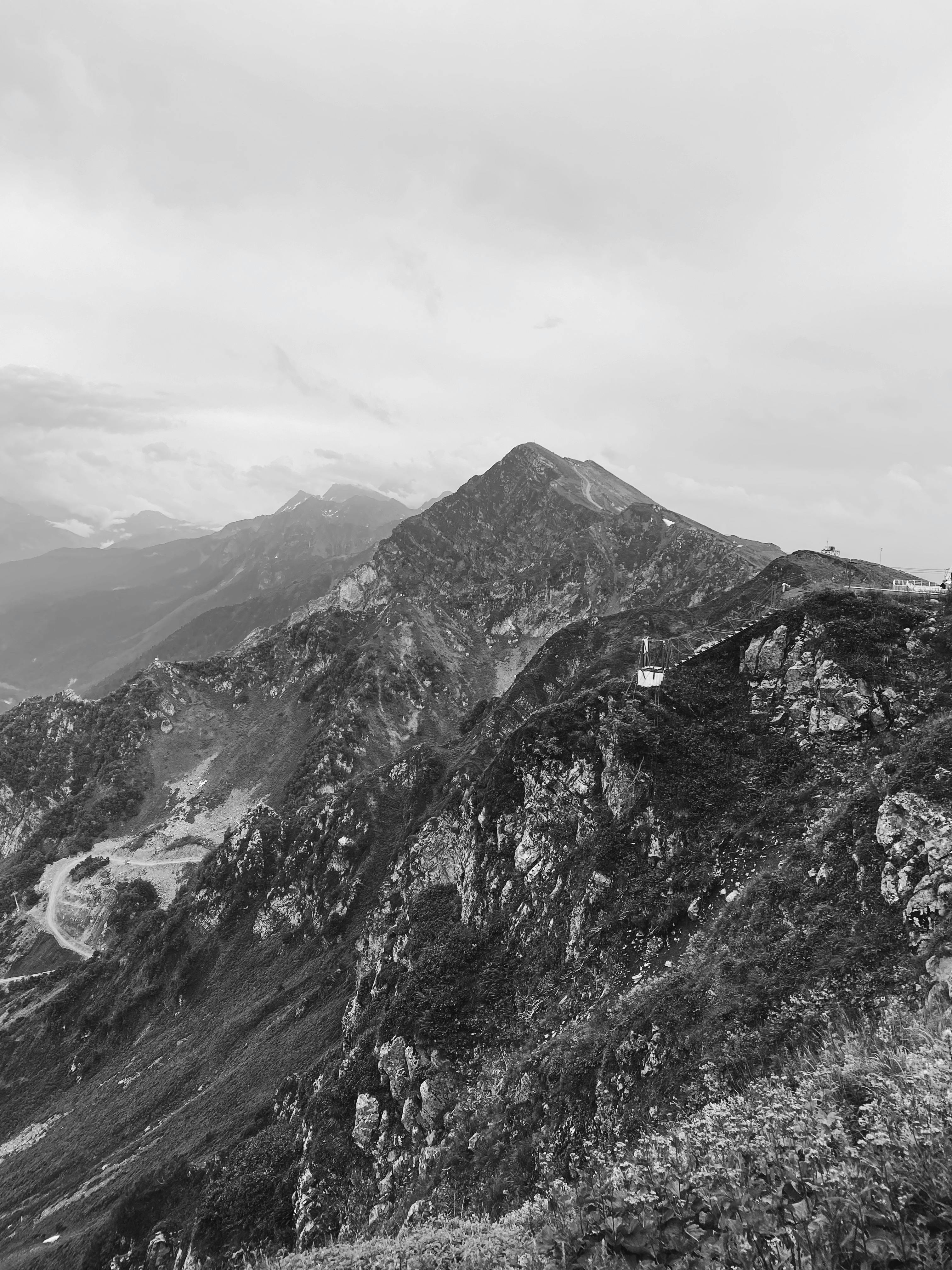 Dramatic aerial view of the rugged mountain peaks in Sochi, Russia captured in black and white.