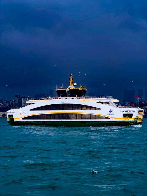 Free A ferry sails under dark, dramatic clouds on the Bosporus in Istanbul, Türkiye. Stock Photo