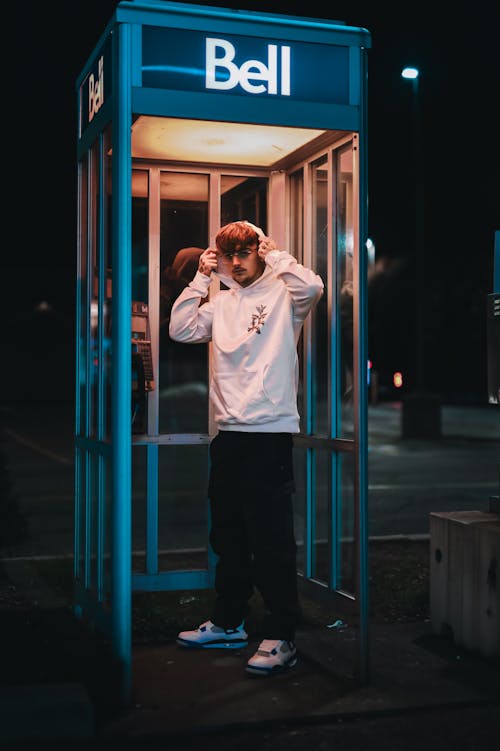 Young Man in Blue Telephone Booth