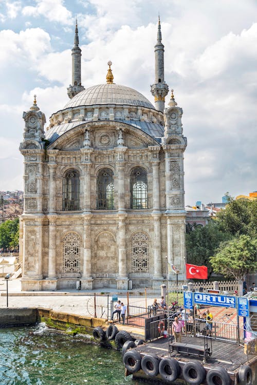 A boat is docked in front of a mosque