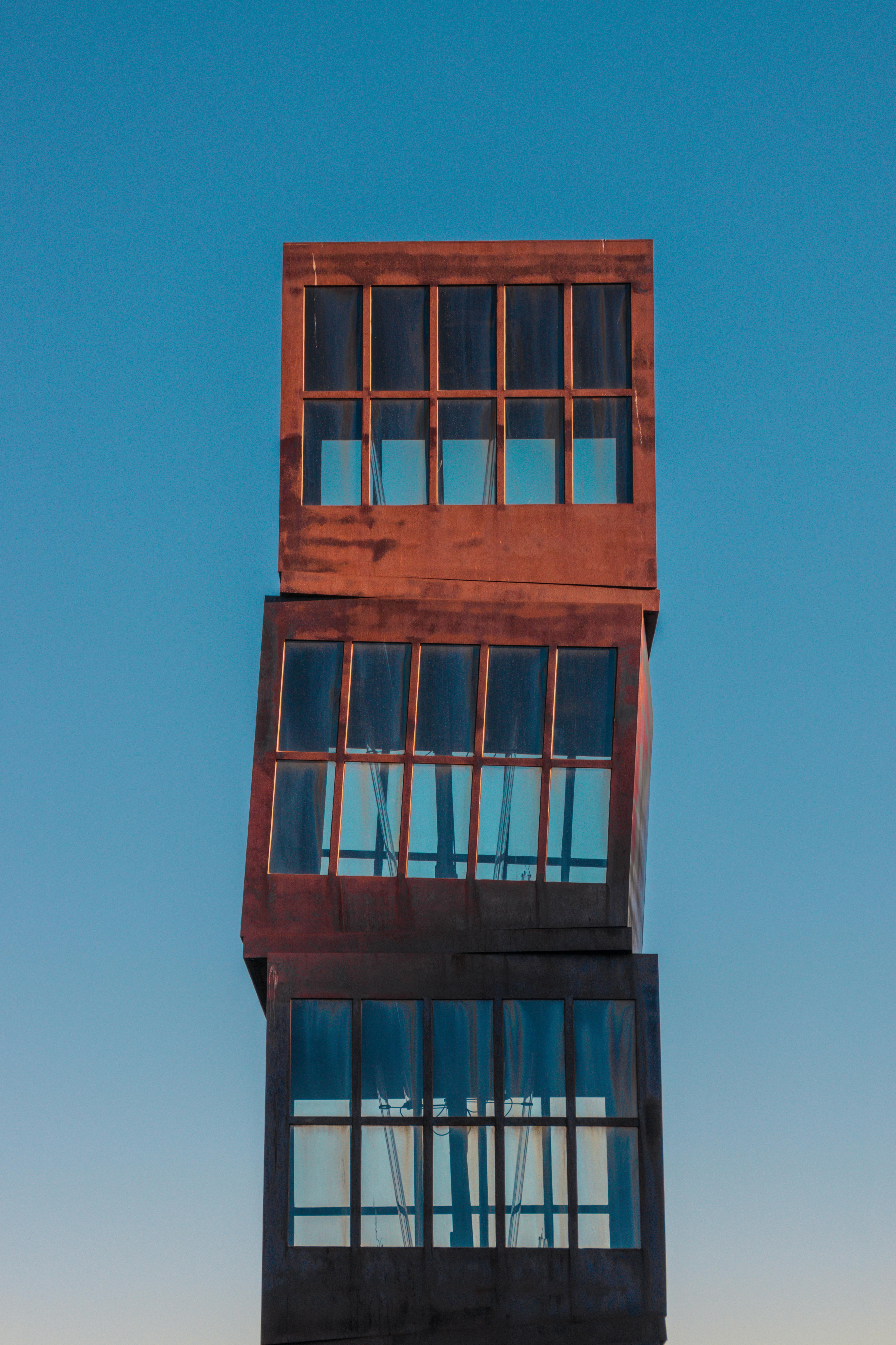 Vertical shot of Estel Ferit sculpture in Barcelona against a clear blue sky.