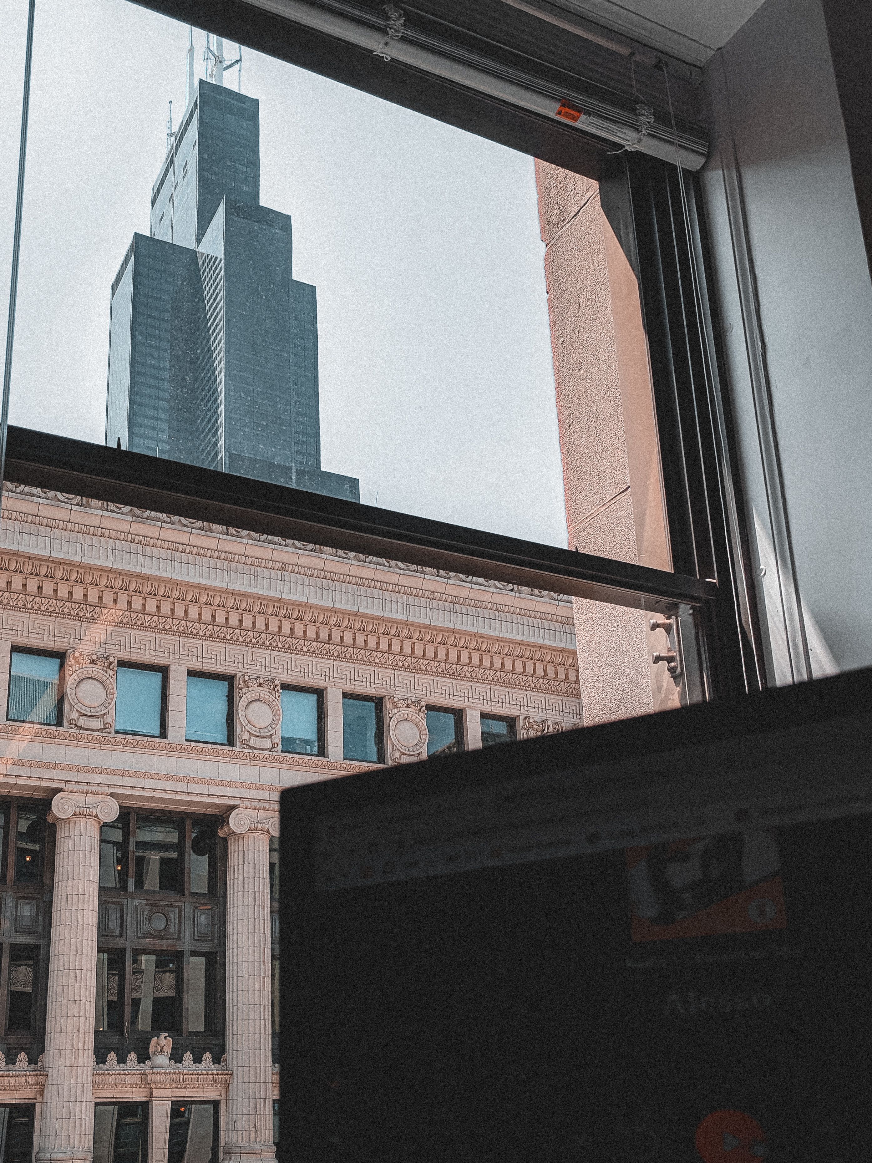 Skyscraper and Building behind Window · Free Stock Photo