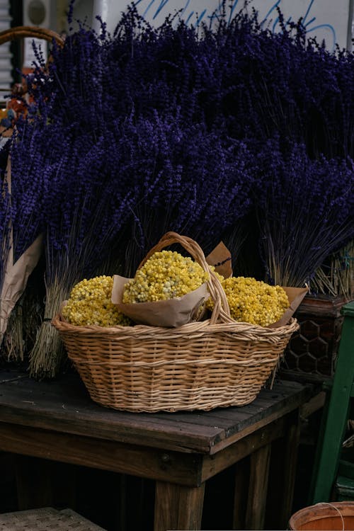 Basket of Yellow Flowers and Bunches of Lavender on a Market Stall