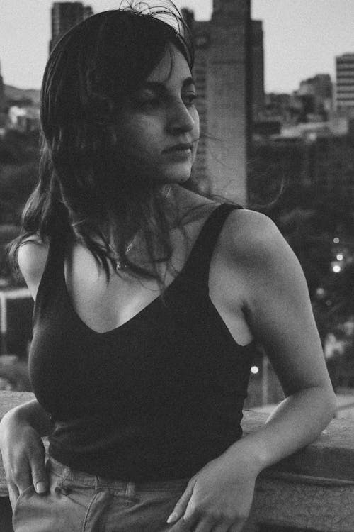 Young Woman on the Balcony of an Apartment Building