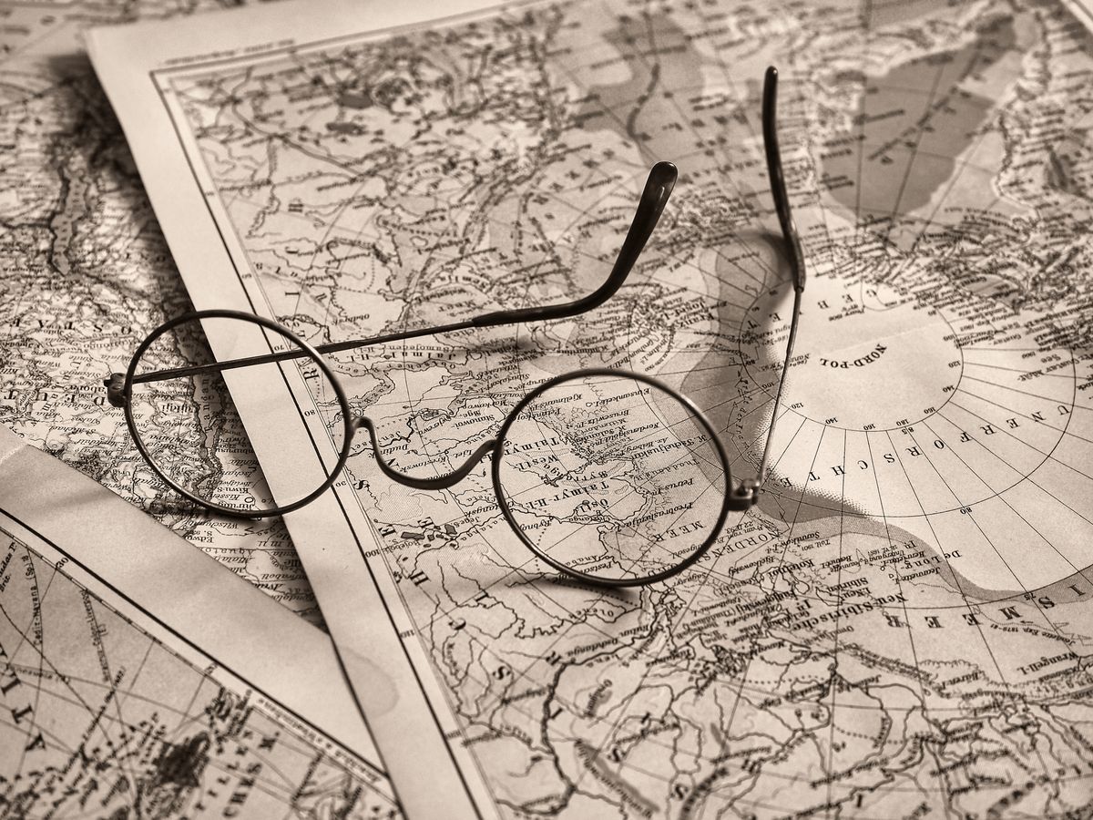 Round glasses resting on a vintage map