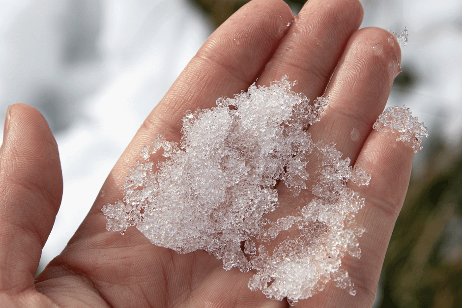 A close-up of a hand holding icy snow in Ushuaia, Argentina.
