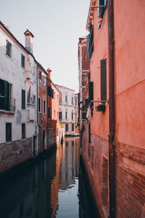 Empty Narrow Canal Between Townhouses in Venice