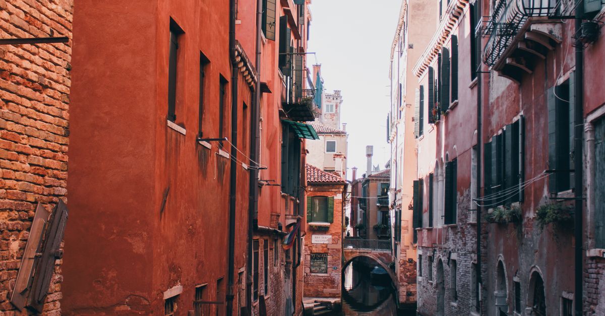 A picturesque view of a Venetian canal lined with gondolas and historic buildings in Venice, Italy.