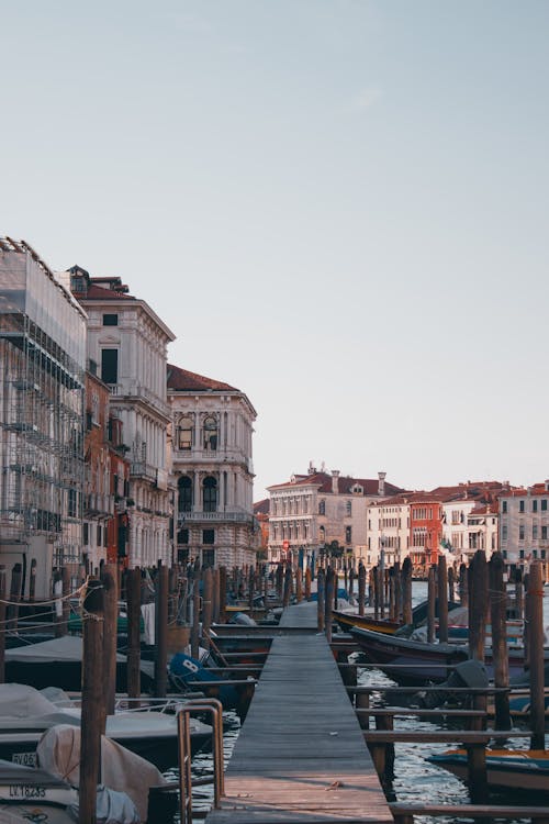 A wooden pier with boats on it in venice