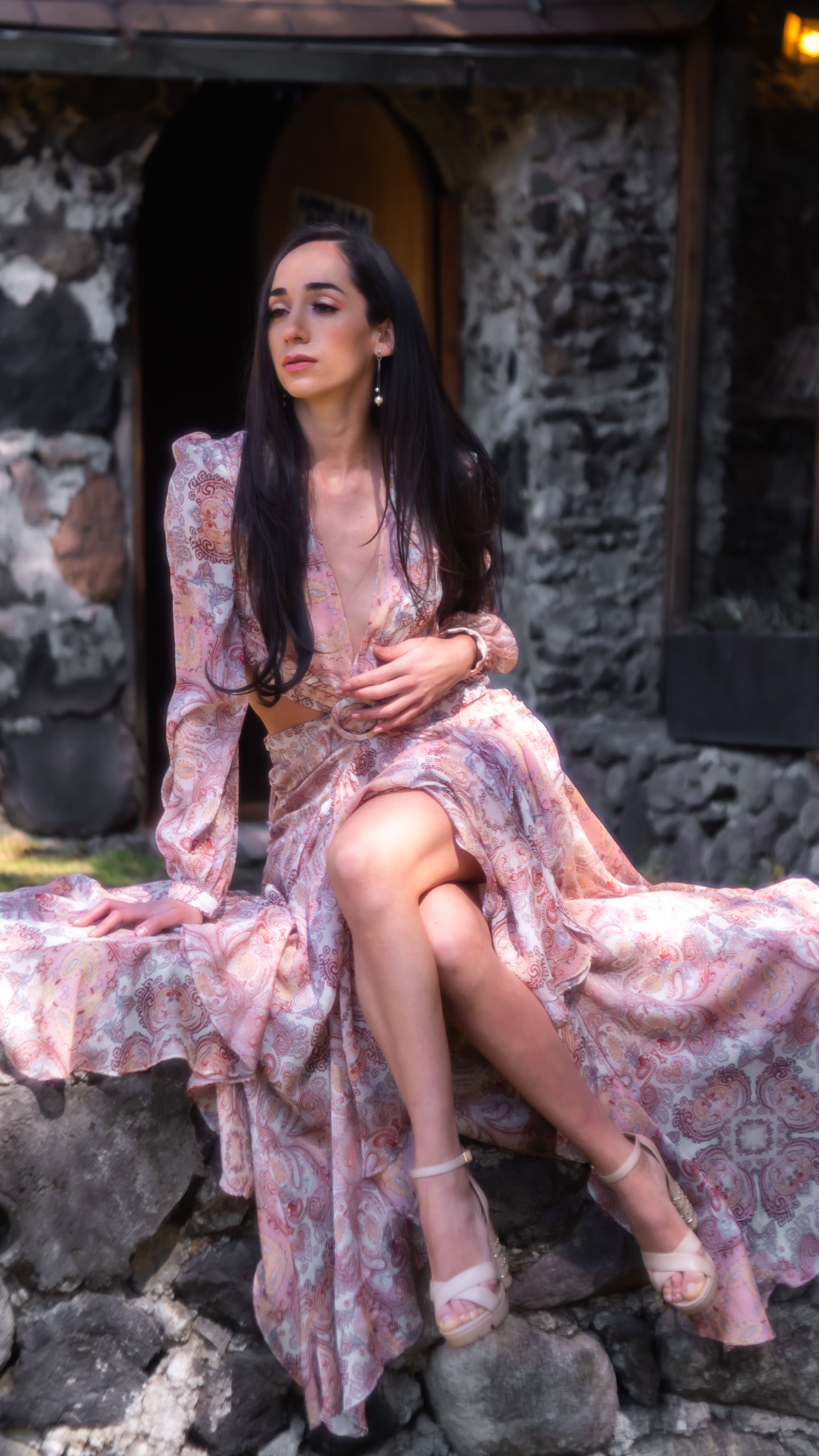 brunette in pink dress Brunette Wearing a Pink Dress, Posing by a Modern Hut Free Stock Photo