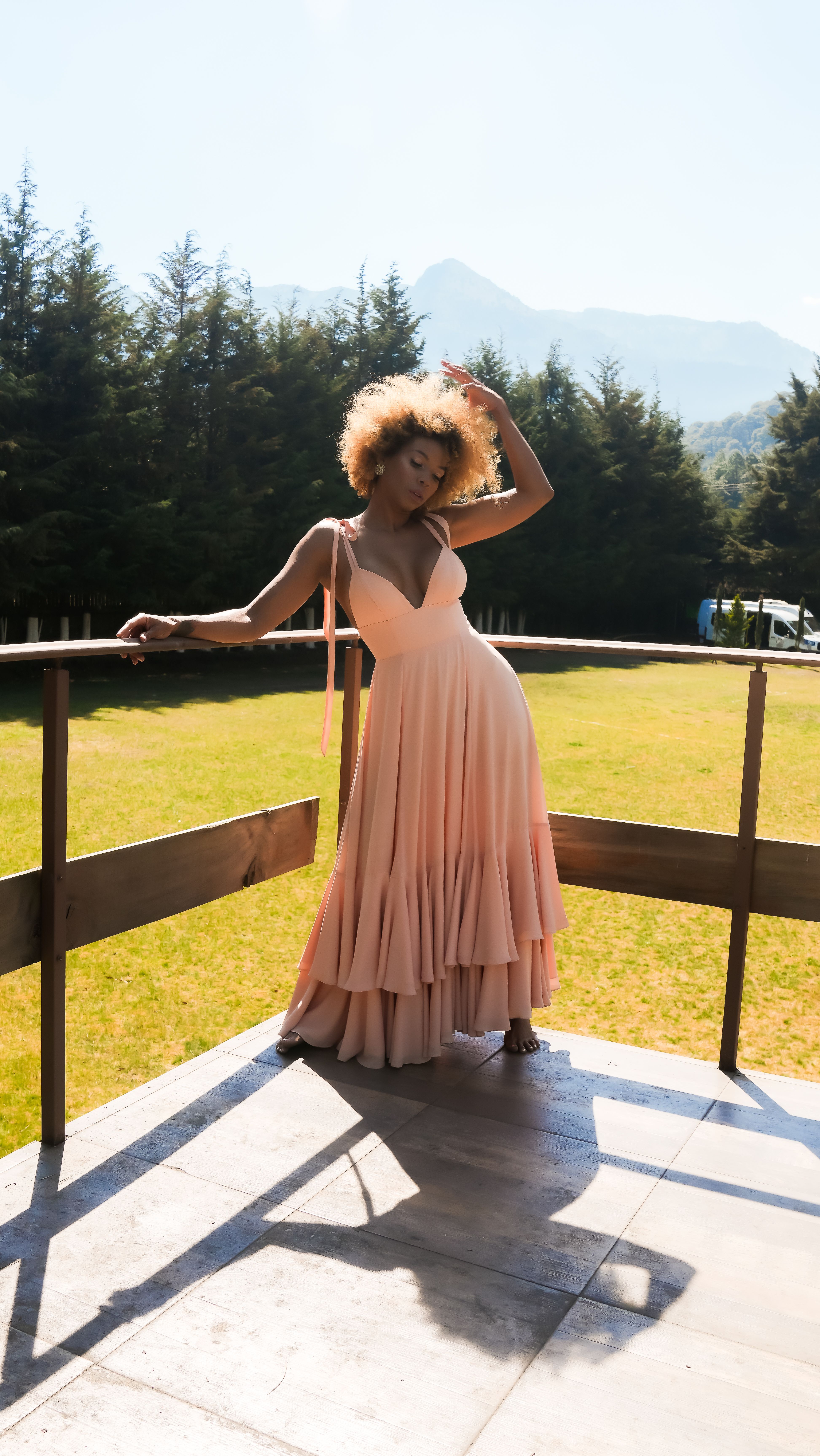 Elegant Woman in a Pink Dress Posing in a Park · Free Stock Photo