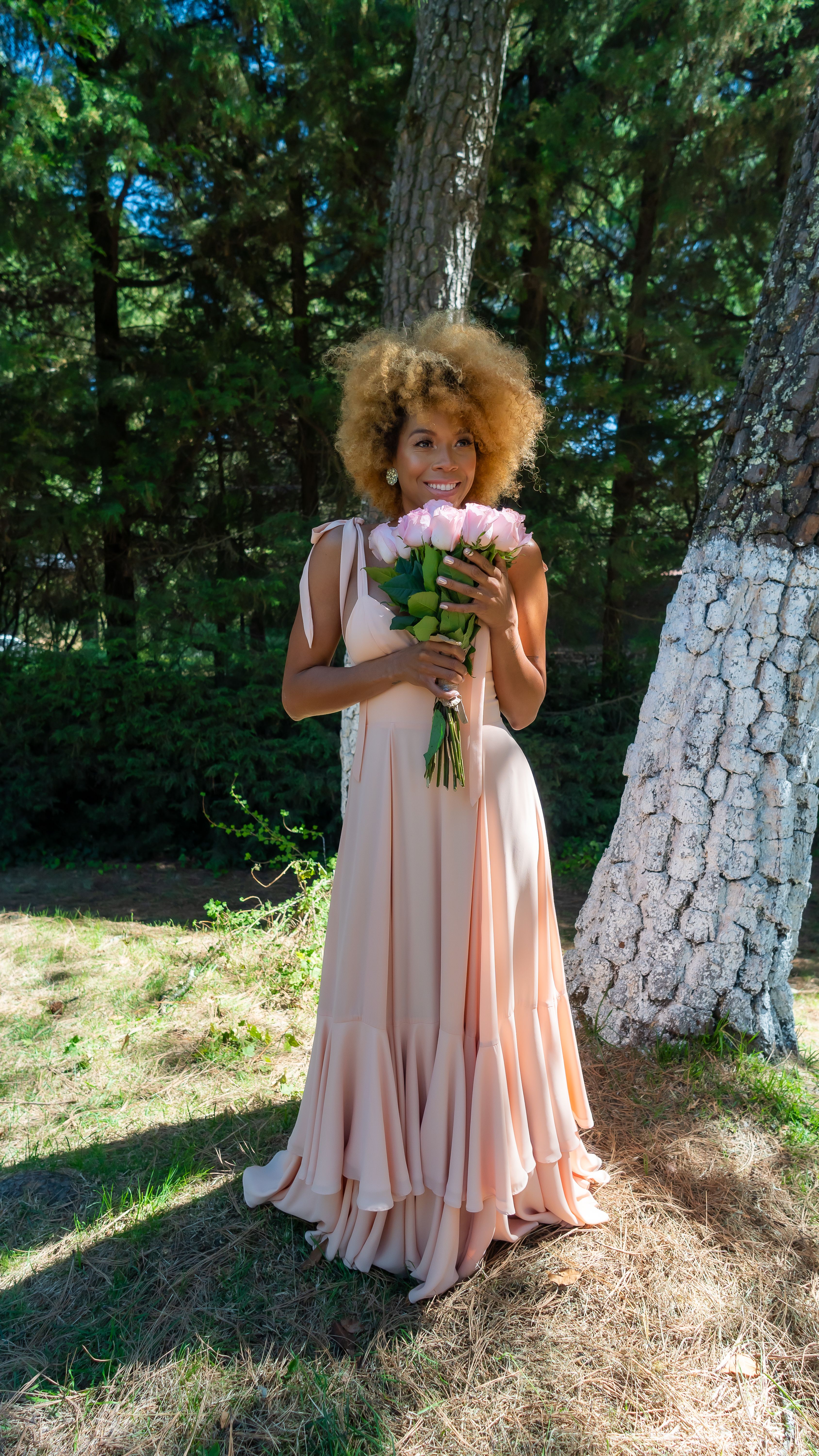 Elegant Woman in a Pink Dress Posing in a Park · Free Stock Photo