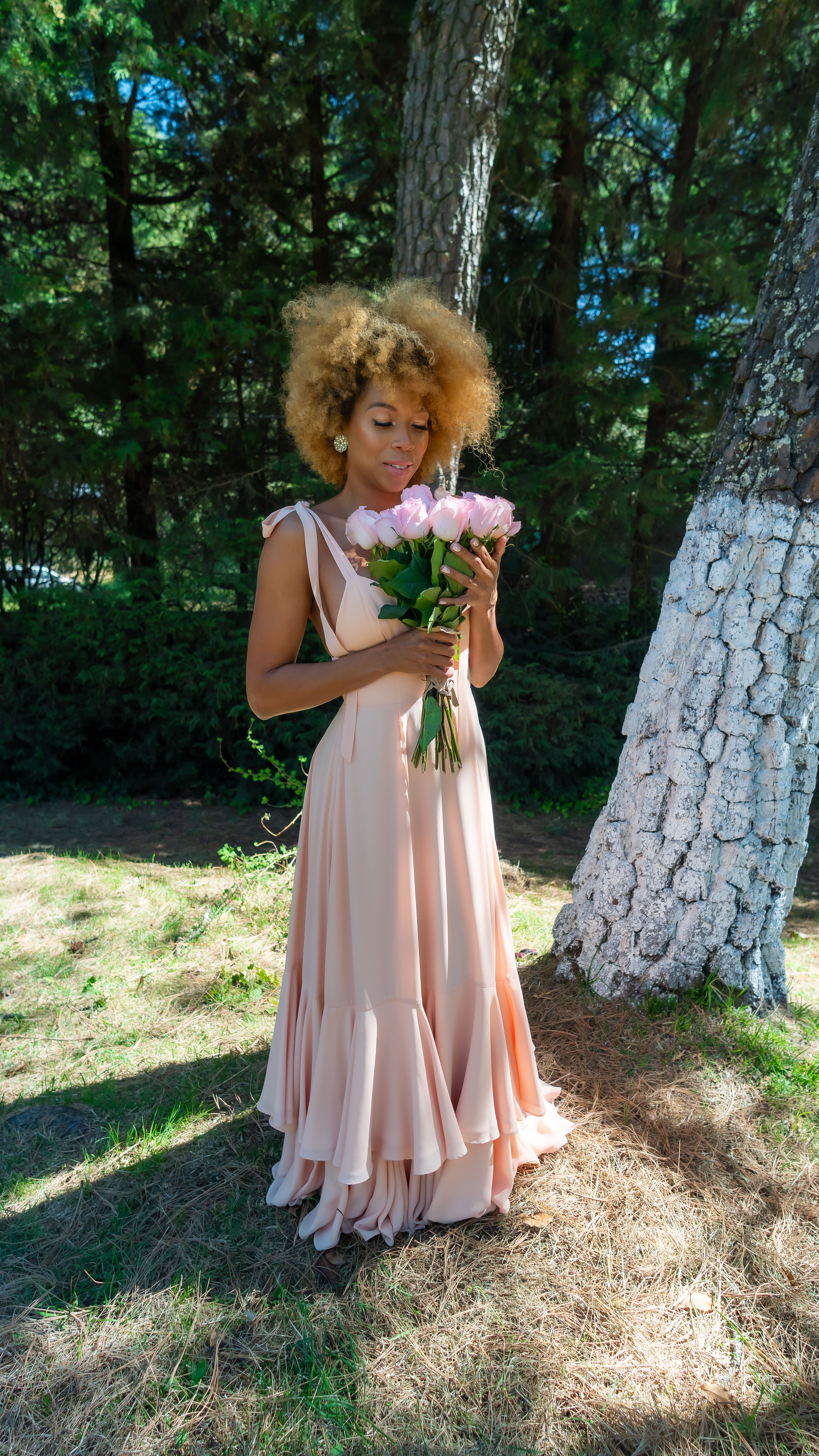 Elegant Woman in a Pink Dress Posing in a Park · Free Stock Photo