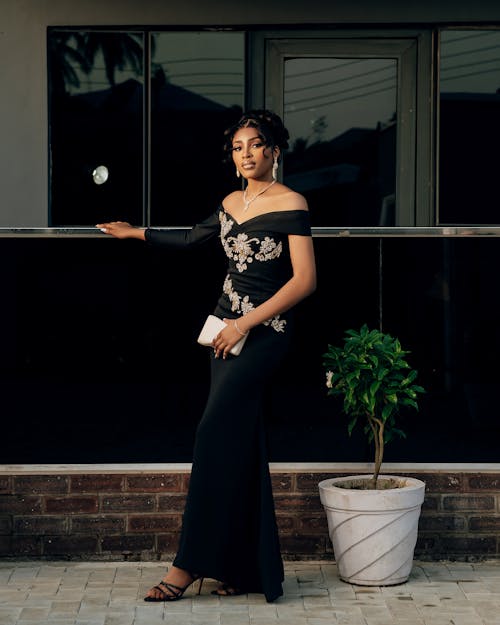 A woman in a black dress posing for the camera