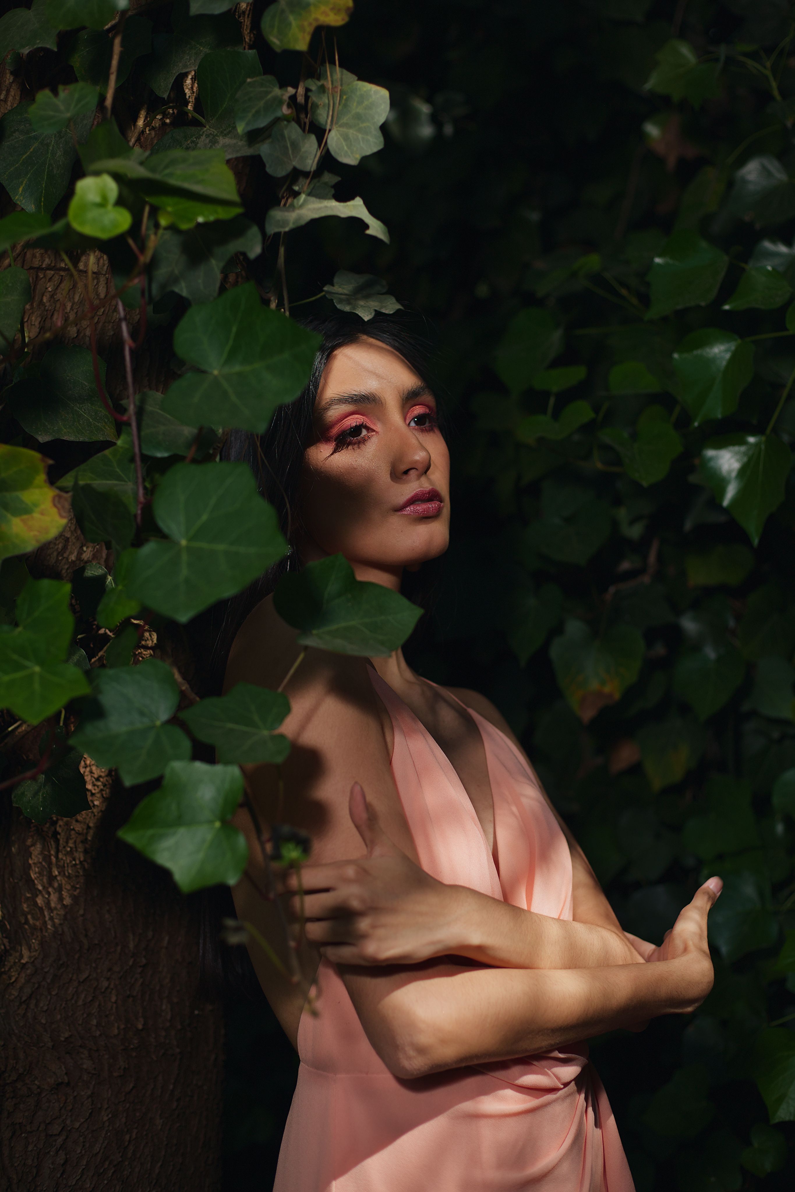 Young Woman in a Pink Dress Leaning against a Tree · Free Stock Photo