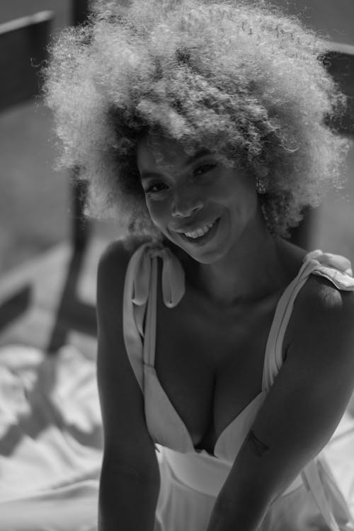 A woman with curly hair and a smile