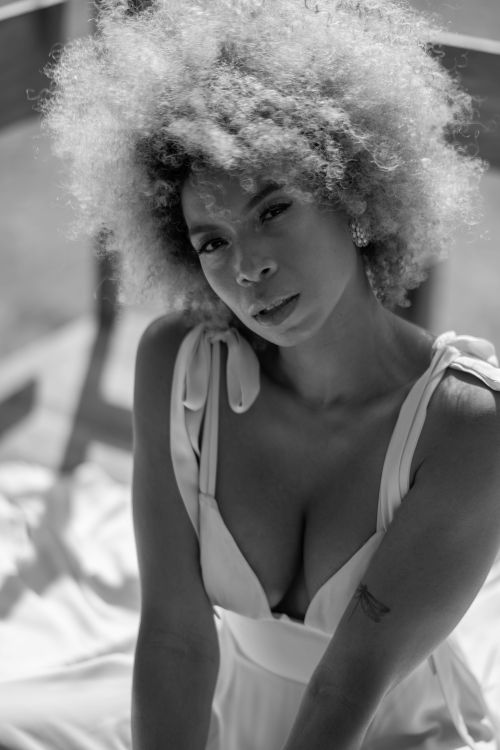 Free Elegant portrait of a woman with curly hair in a stylish dress, captured in Mexico City. Stock Photo
