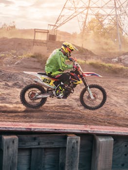 Exciting action shot of a motocross rider speeding through a dirt track in full gear.