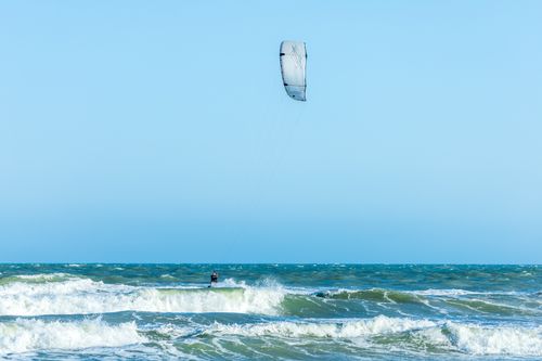 Free Kite surfer enjoying thrilling ocean ride. Perfect for adventure and water sport enthusiasts. Stock Photo