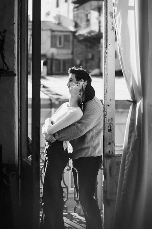 Hugging Couple in Doorway in Black and White