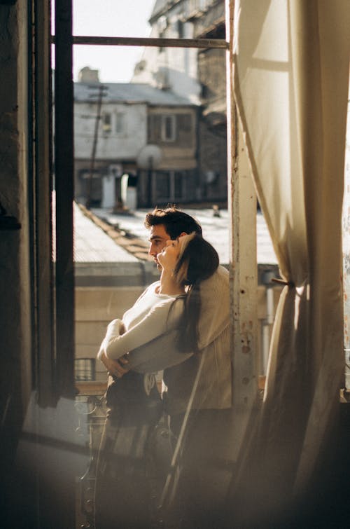 A woman is looking out of a window