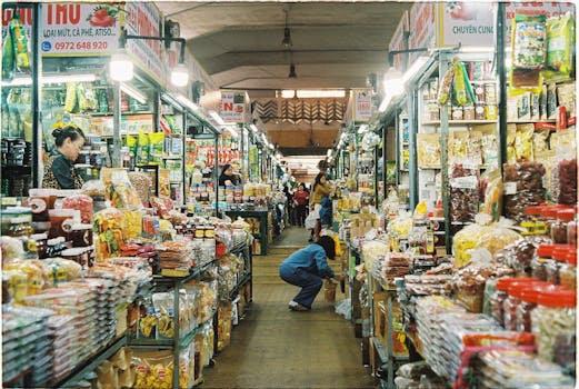 Vibrant shopping aisle at a bustling market in Dalat, Vietnam, showcasing diverse goods.