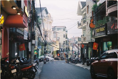 Free Explore the bustling streets of Dalat, Vietnam filled with motorbikes and vibrant urban life. Stock Photo