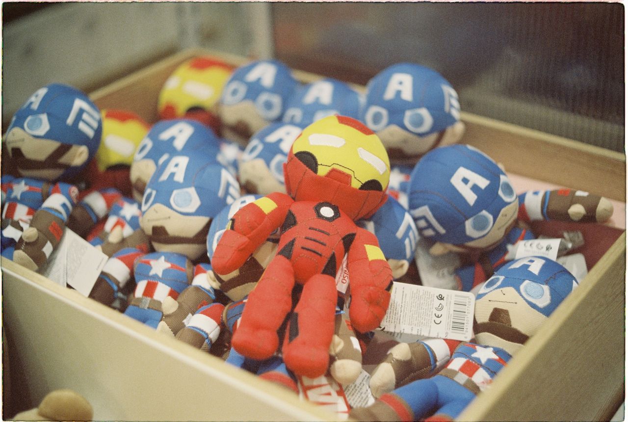 a vibrant collection of superhero dolls displayed in a box bright and