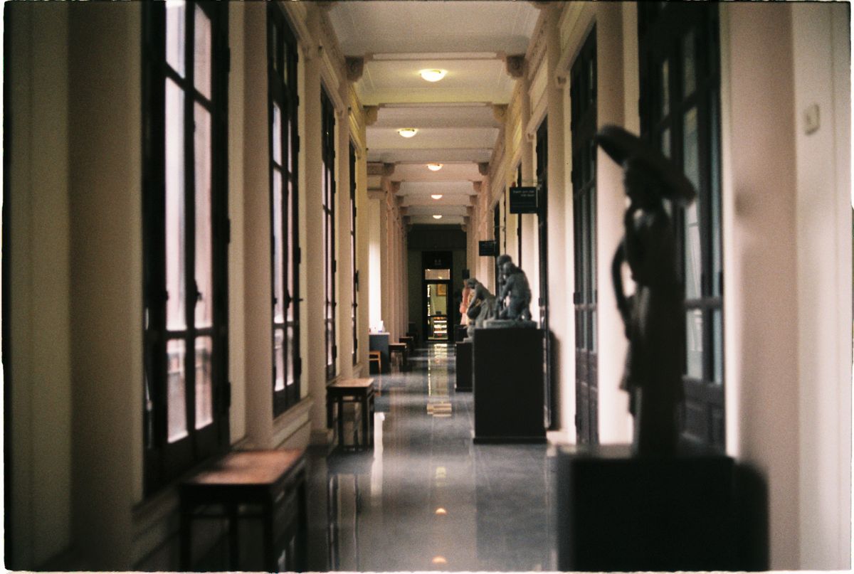 Sculptures displayed along a sunlit museum corridor in Hanoi