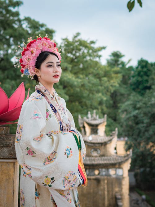 A woman in traditional chinese clothing poses for a photo