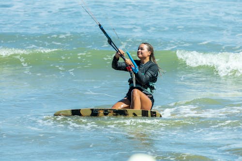 Woman Kitesurfing on Sea Shore
