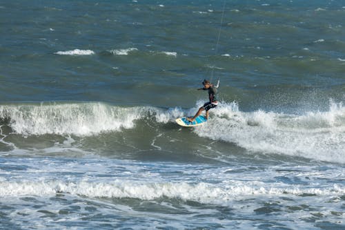 Man Kitesurfing on Sea Shore