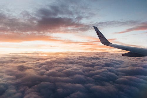Free White Airliner Wing on Top of Sea Clouds Stock Photo