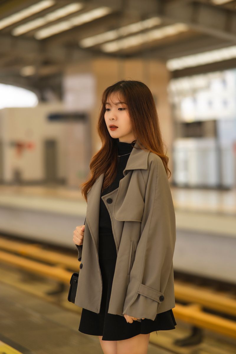 Woman in trench coat portrait street style