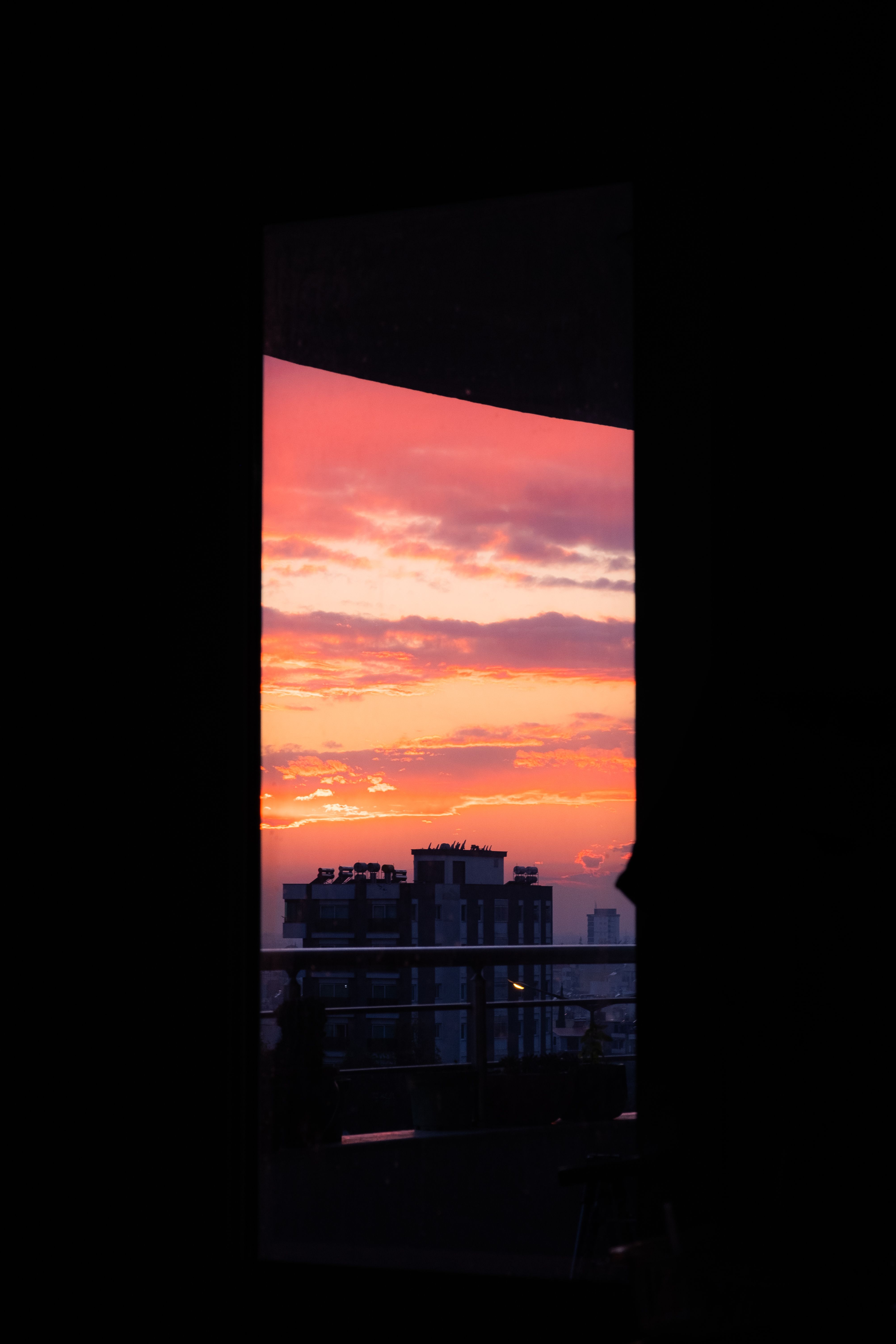 Building behind Window in Room Darkness at Sunset · Free Stock Photo