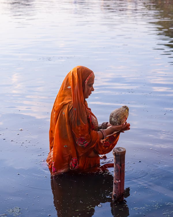 Woman in Traditional Clothing in Ritual in Lake · Free Stock Photo