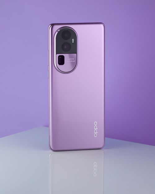 Free Purple smartphone on reflective surface against a purple backdrop, showcasing modern design. Stock Photo