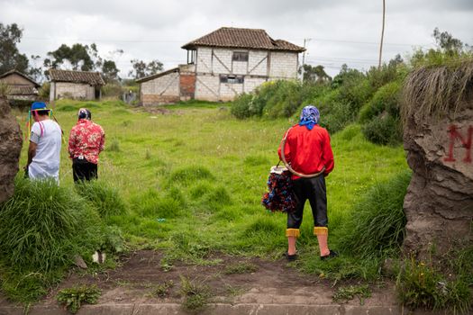 People in vibrant costumes in a rural village showcasing traditional dress and cultural heritage.