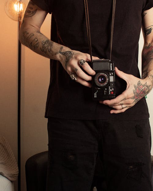 Free Man Wearing Black Shirt Holding Camera Stock Photo
