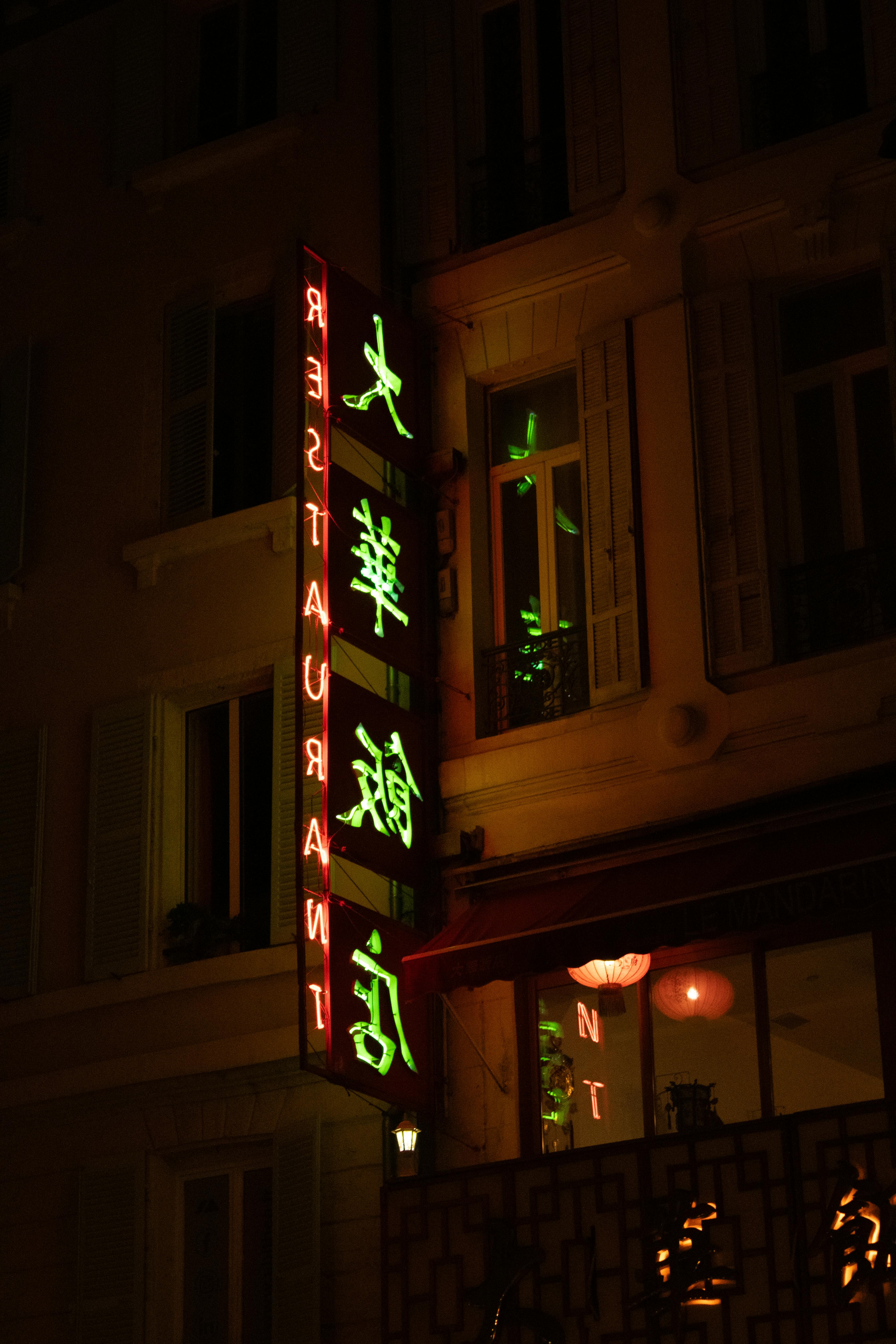A neon-lit Chinese restaurant signage glowing at night in Marseille, France.