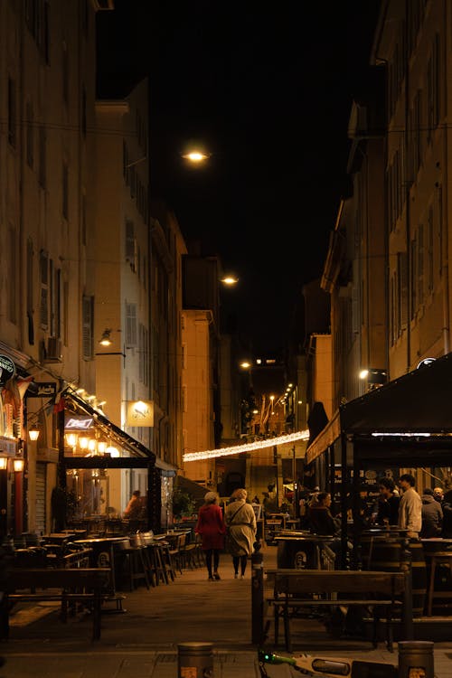 Alley with Restaurants in City at Night