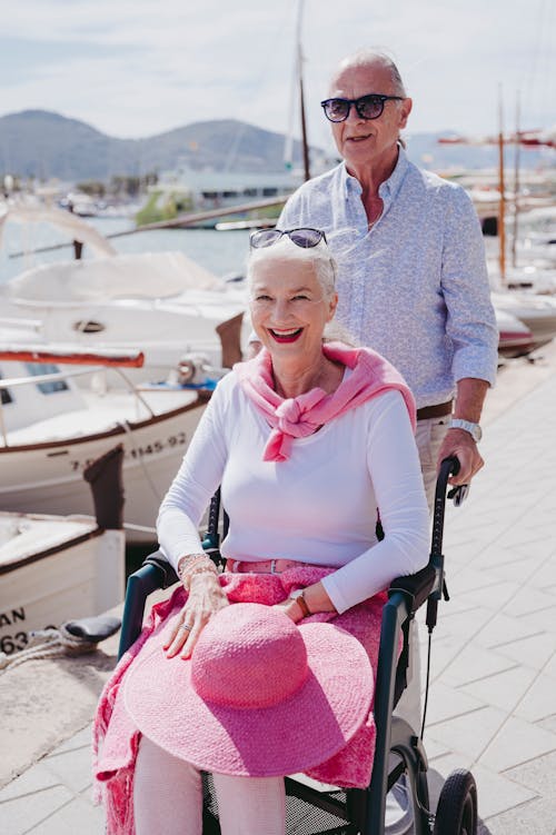 Smiling Woman on Wheelchair with Man behind
